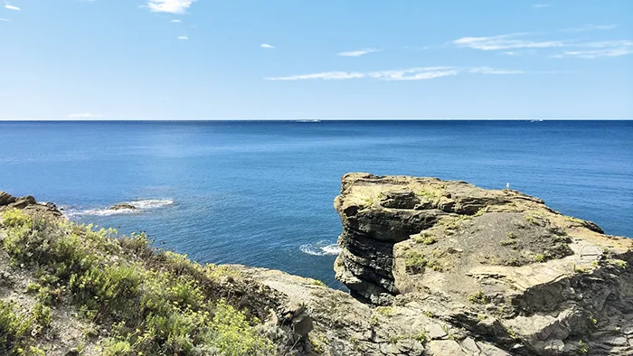 Scogliera sul mare blu con vista panoramica dell'orizzonte