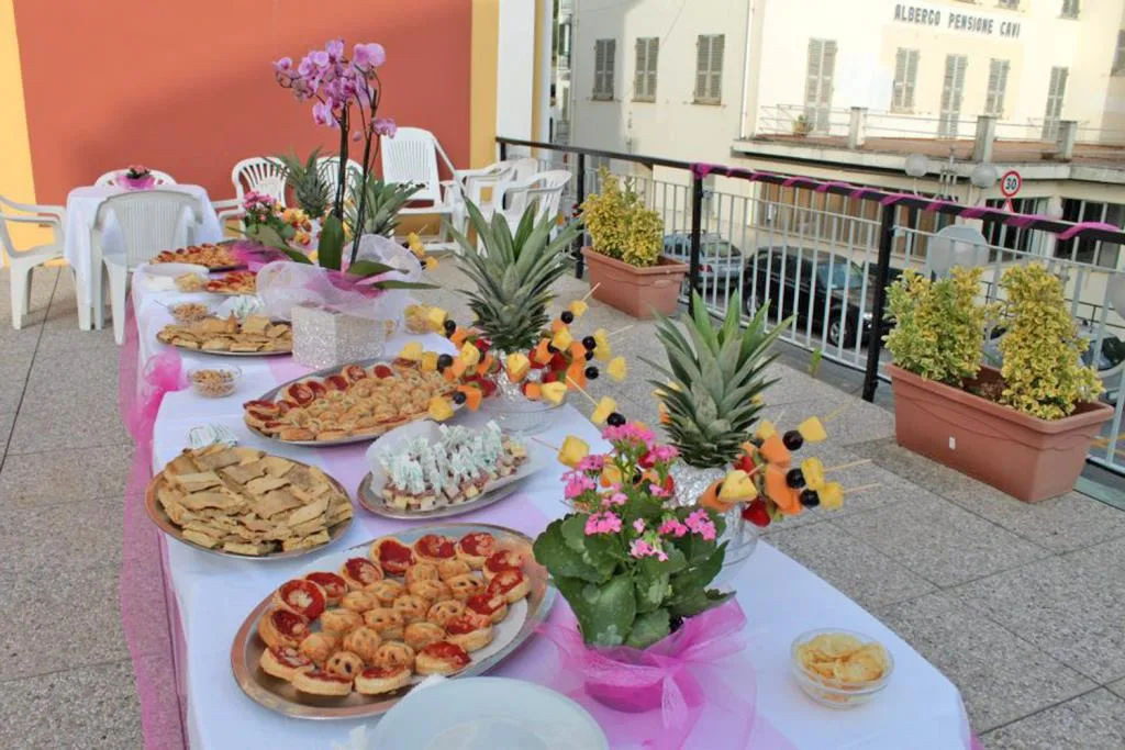 Buffet di stuzzichini e frutta decorato con fiori su una terrazza
