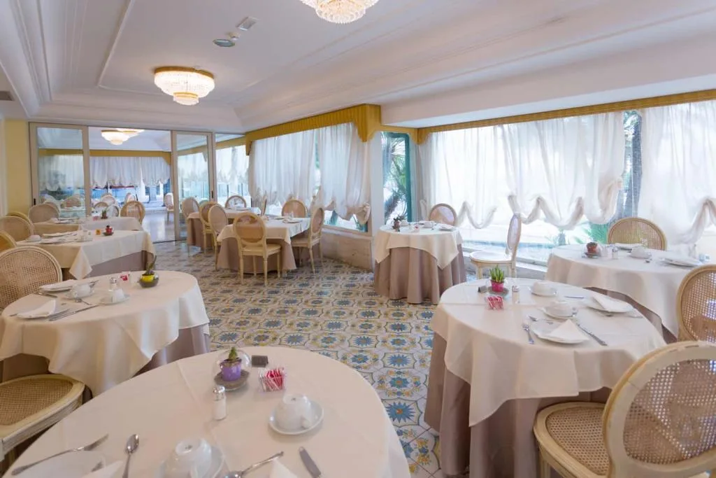 Sala colazione elegante con pavimento decorato e tende